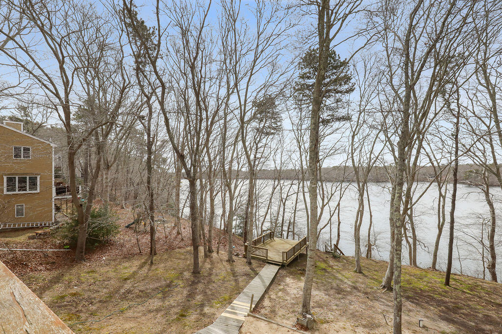 75 Edgewater Road Mashpee, MA 02649 - Photo 65 of 78 a backyard of a house with table and chairs