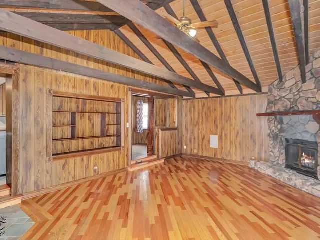 a view of an empty room with a fireplace