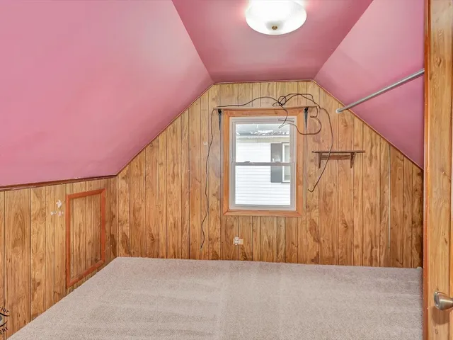 a view of a house with a yard and a large tree