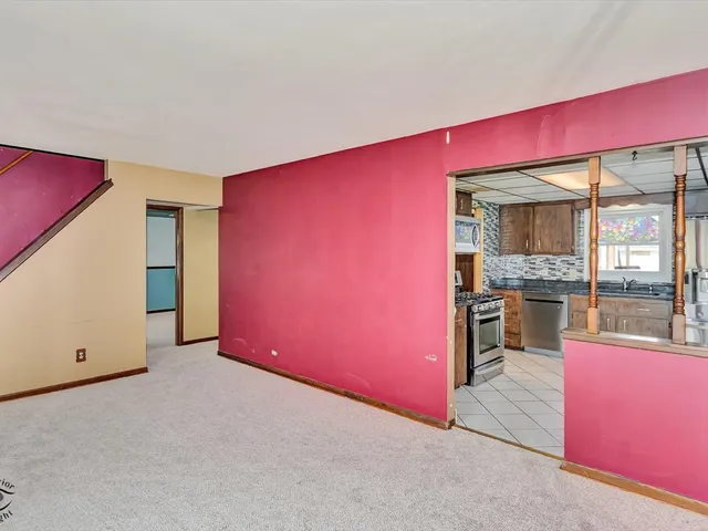 a view of a living room with stainless steel appliances