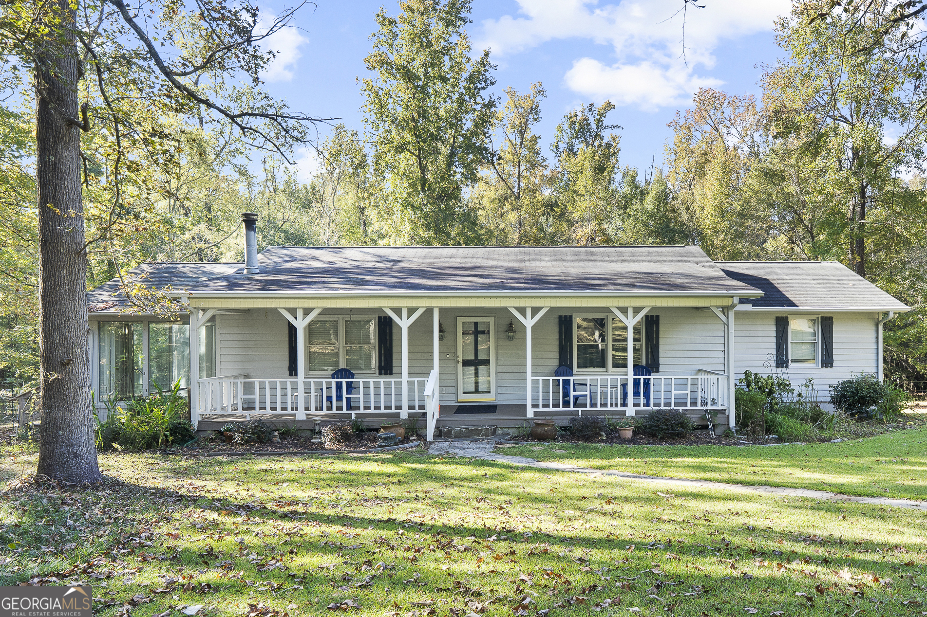 a front view of a house with swimming pool and porch