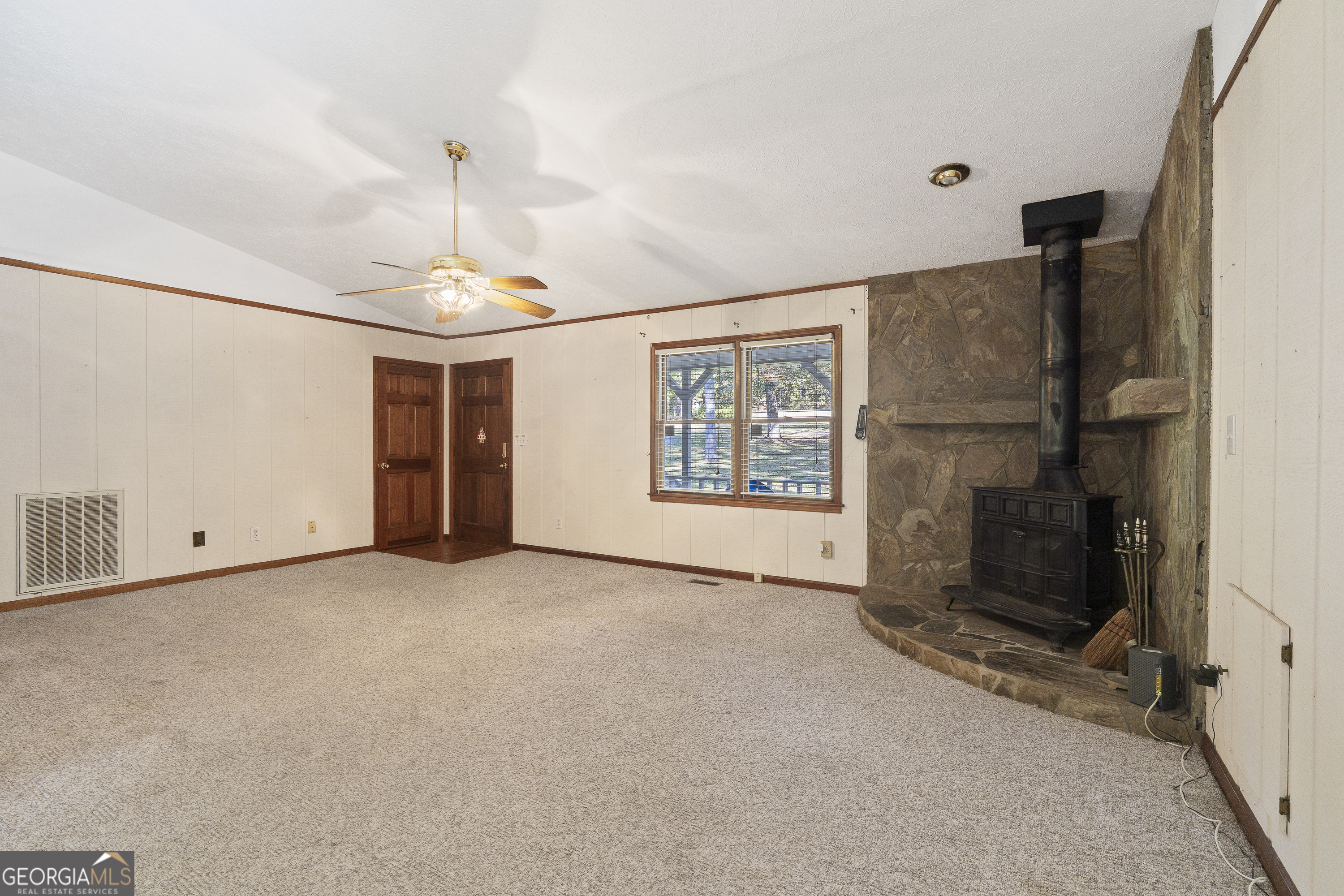 124 Coppergate Lane Macon, GA 31211 - Photo 12 of 46 an empty room with windows chandelier fan and windows