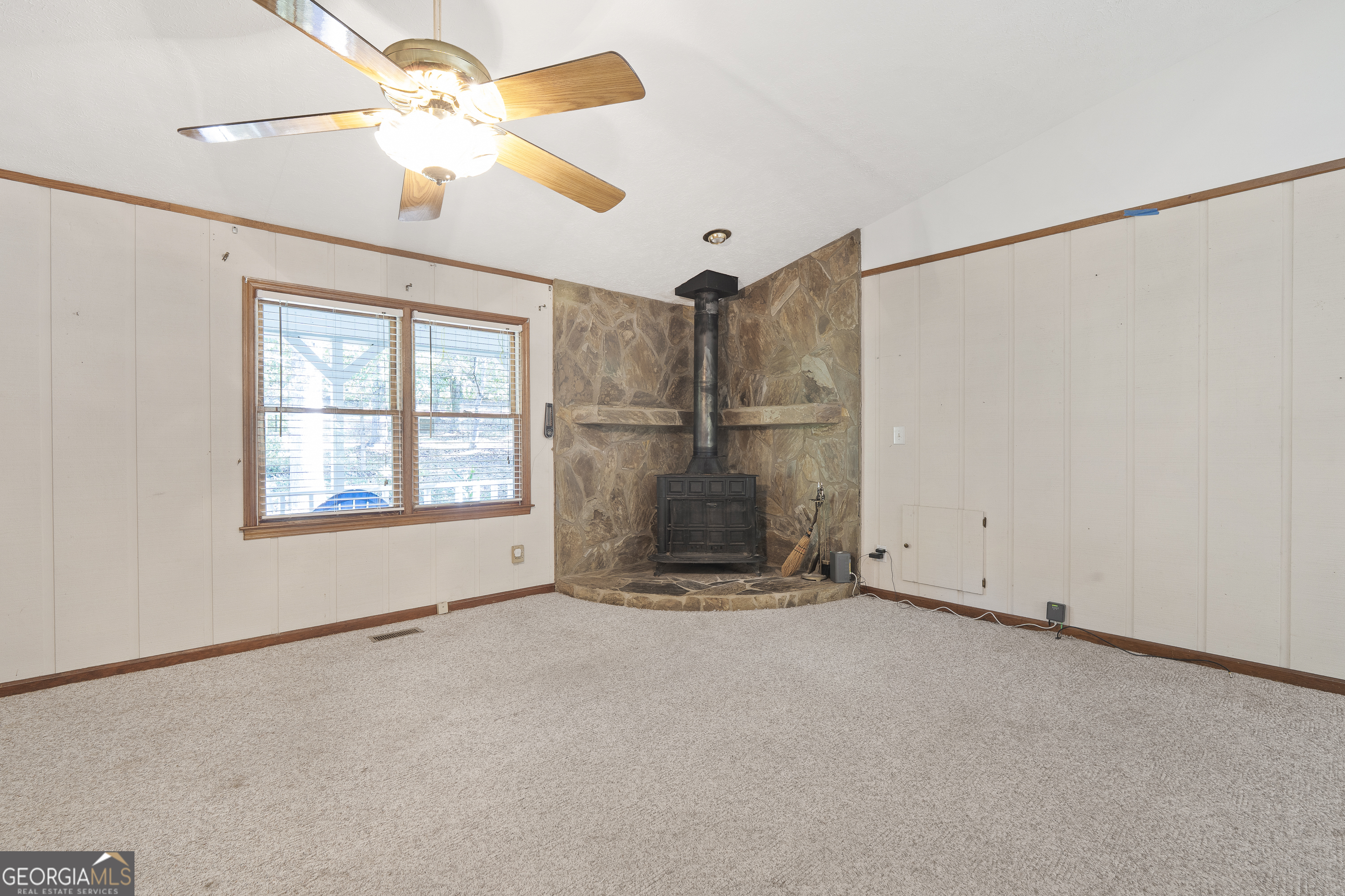 124 Coppergate Lane Macon, GA 31211 - Photo 13 of 46 an empty room with chandelier fan and windows