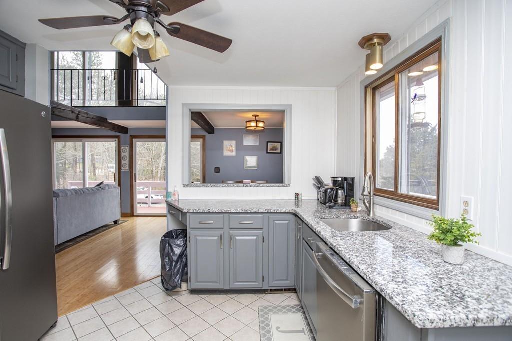 51 Edgewater Way Wareham, MA 02571 - Photo 29 of 42 a kitchen with granite countertop a sink a counter top space and living room