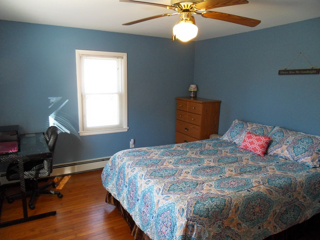 285 Thompson Road Webster, MA 01570 - Photo 12 of 20 a bedroom with a bed and wooden floor
