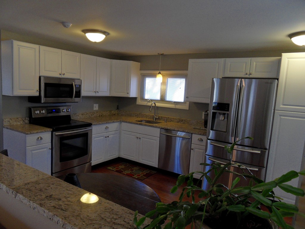285 Thompson Road Webster, MA 01570 - Photo 4 of 20 a kitchen with a refrigerator stove and microwave
