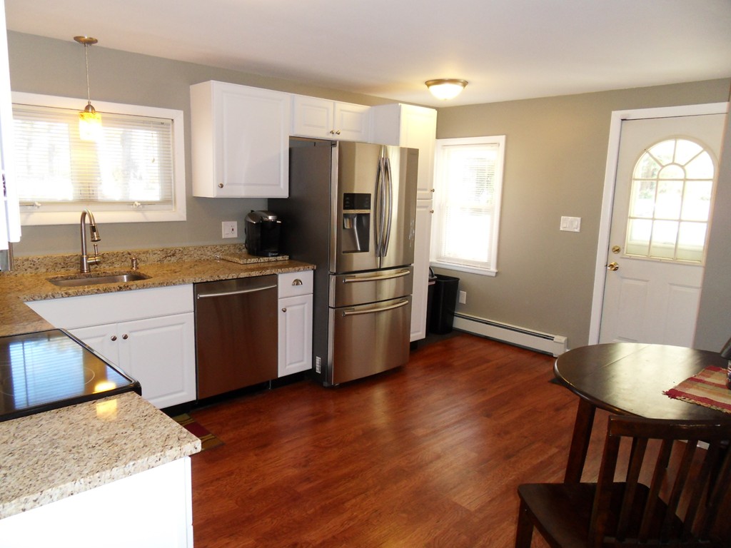 285 Thompson Road Webster, MA 01570 - Photo 5 of 20 a kitchen with stainless steel appliances granite countertop a stove a sink a refrigerator and island