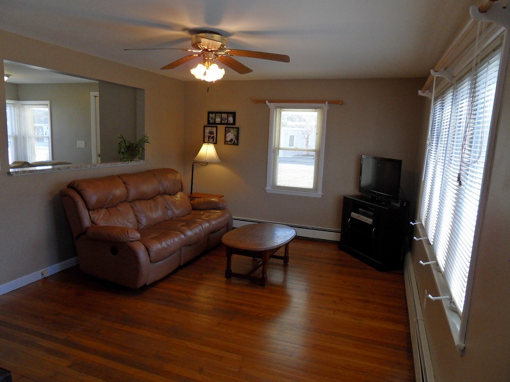 285 Thompson Road Webster, MA 01570 - Photo 8 of 20 a living room with furniture a fireplace and a window