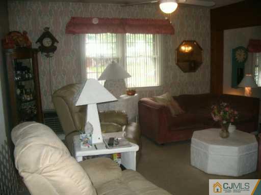 45 Greenbrook Road Middlesex, NJ 08846 - Photo 8 of 8 a living room with furniture and a chandelier