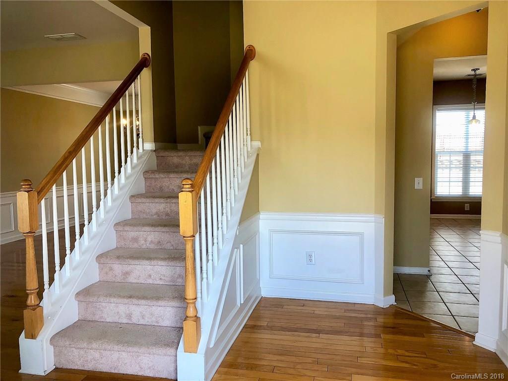 2401 Coltsgate Road Waxhaw, NC 28173 - Photo 2 of 22 a view of a hallway with wooden floor and staircase