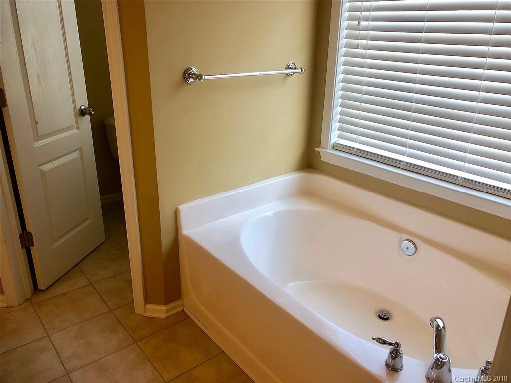 2401 Coltsgate Road Waxhaw, NC 28173 - Photo 12 of 22 a bathroom with a tub and shower
