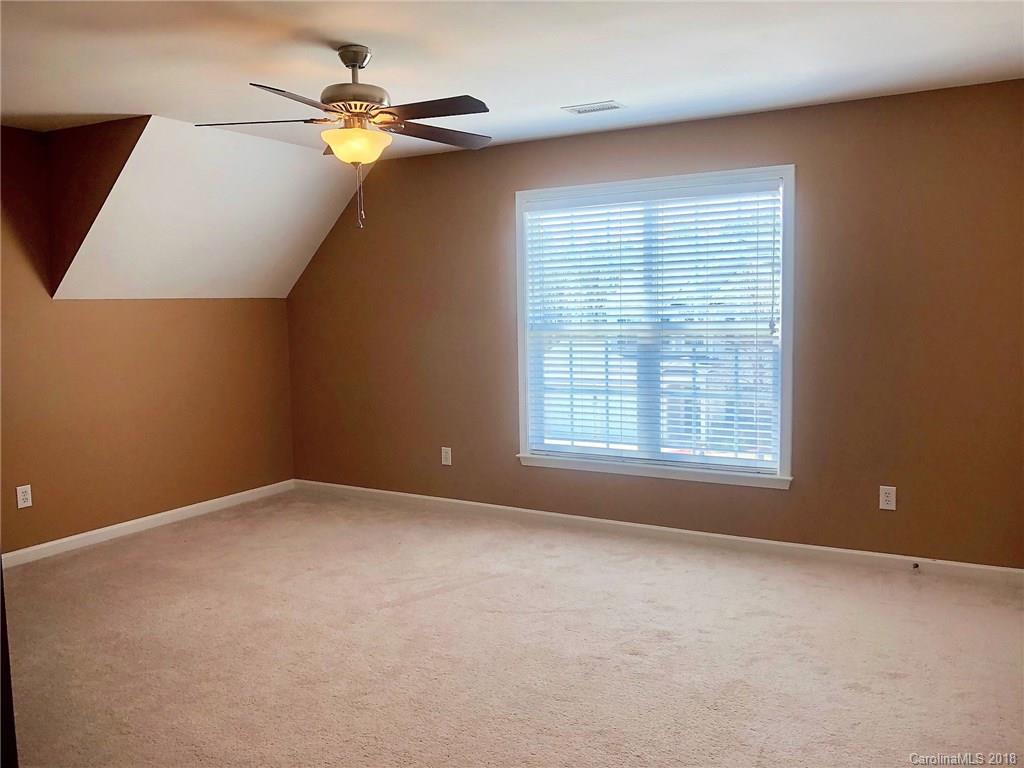 2401 Coltsgate Road Waxhaw, NC 28173 - Photo 13 of 22 an empty room with windows and fan