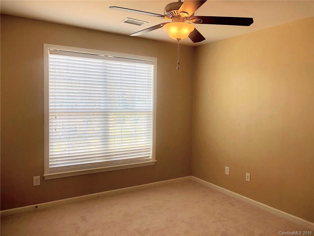 2401 Coltsgate Road Waxhaw, NC 28173 - Photo 14 of 22 an empty room with windows and fan