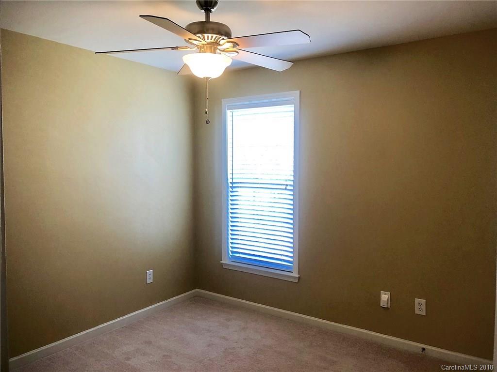 2401 Coltsgate Road Waxhaw, NC 28173 - Photo 16 of 22 an empty room with a window and a fan