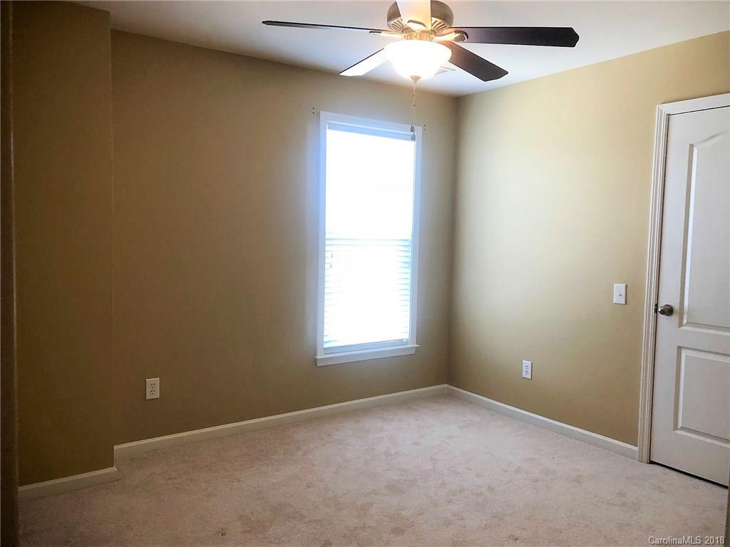 2401 Coltsgate Road Waxhaw, NC 28173 - Photo 17 of 22 an empty room with a window and a fan