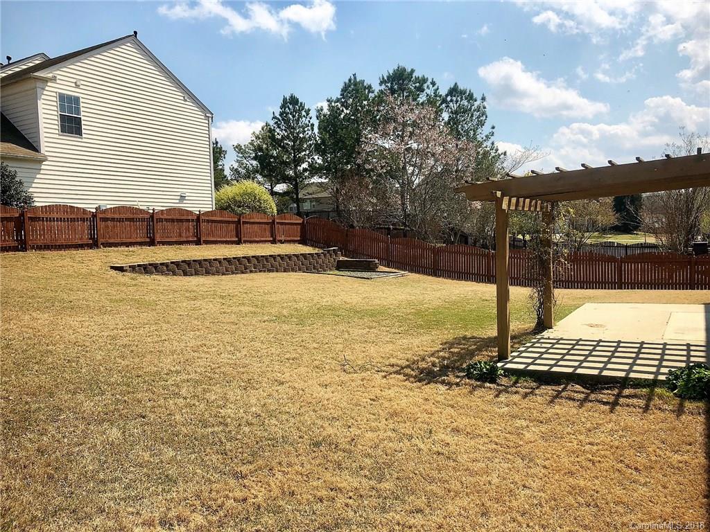 2401 Coltsgate Road Waxhaw, NC 28173 - Photo 19 of 22 a view of a pool with a yard