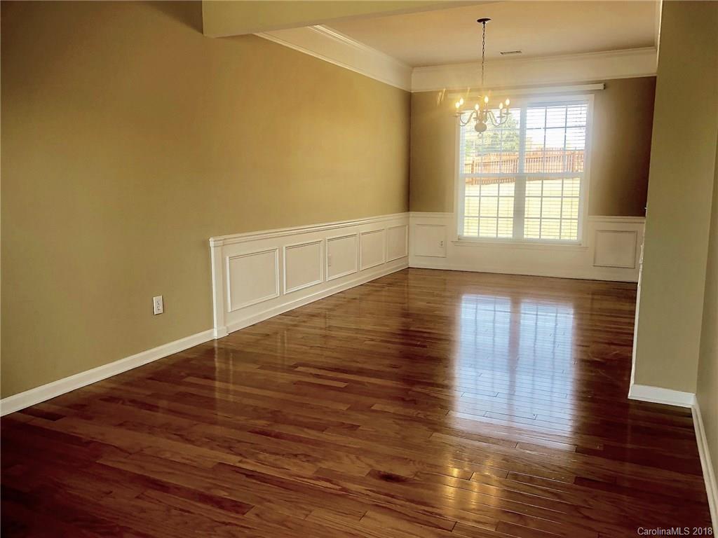2401 Coltsgate Road Waxhaw, NC 28173 - Photo 3 of 22 an empty room with wooden floor and windows
