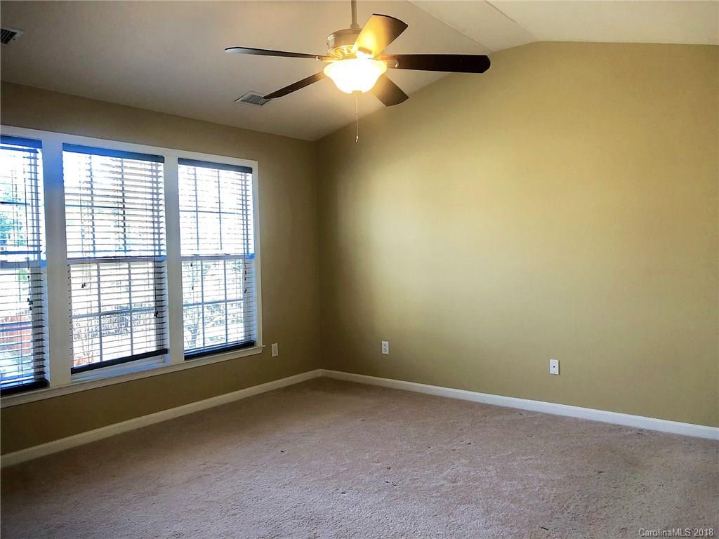 2401 Coltsgate Road Waxhaw, NC 28173 - Photo 10 of 22 an empty room with a empty space and a ceiling fan