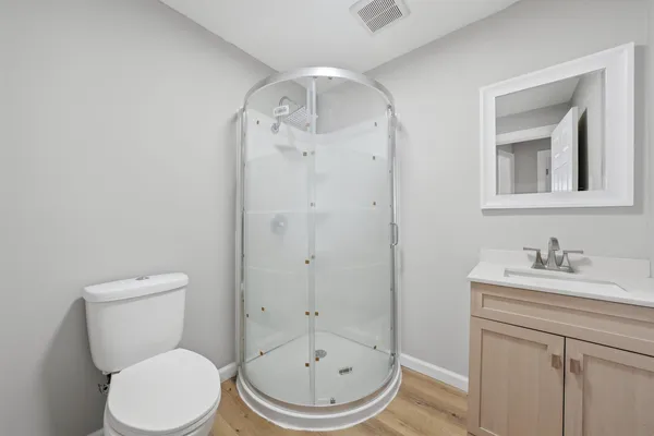 a bathroom with a toilet a sink and mirror