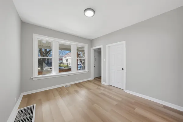 an empty room with windows and closet