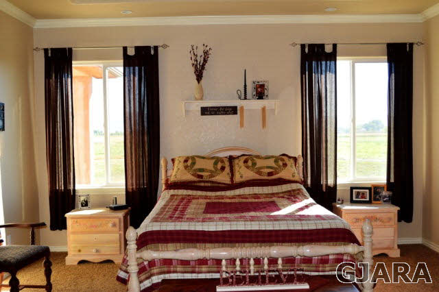 1575 15 Road Loma, CO 81524 - Photo 11 of 30 a bed sitting in a bedroom next to a window