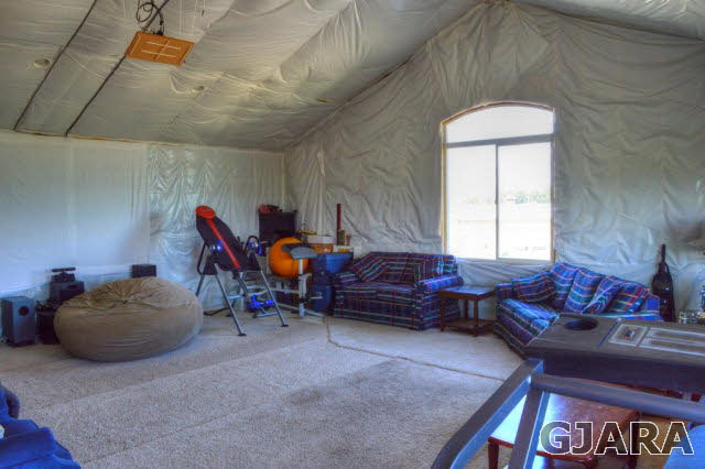 1575 15 Road Loma, CO 81524 - Photo 22 of 30 a living room with furniture a air conditioner vent and a window