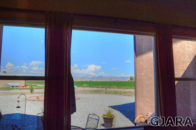 1575 15 Road Loma, CO 81524 - Photo 24 of 30 a view of a balcony with chair and floor to ceiling window