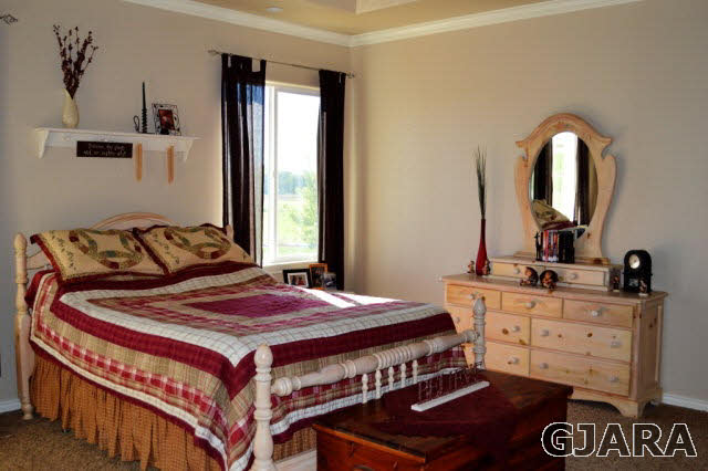 1575 15 Road Loma, CO 81524 - Photo 10 of 30 a bedroom with a bed and dresser with mirror