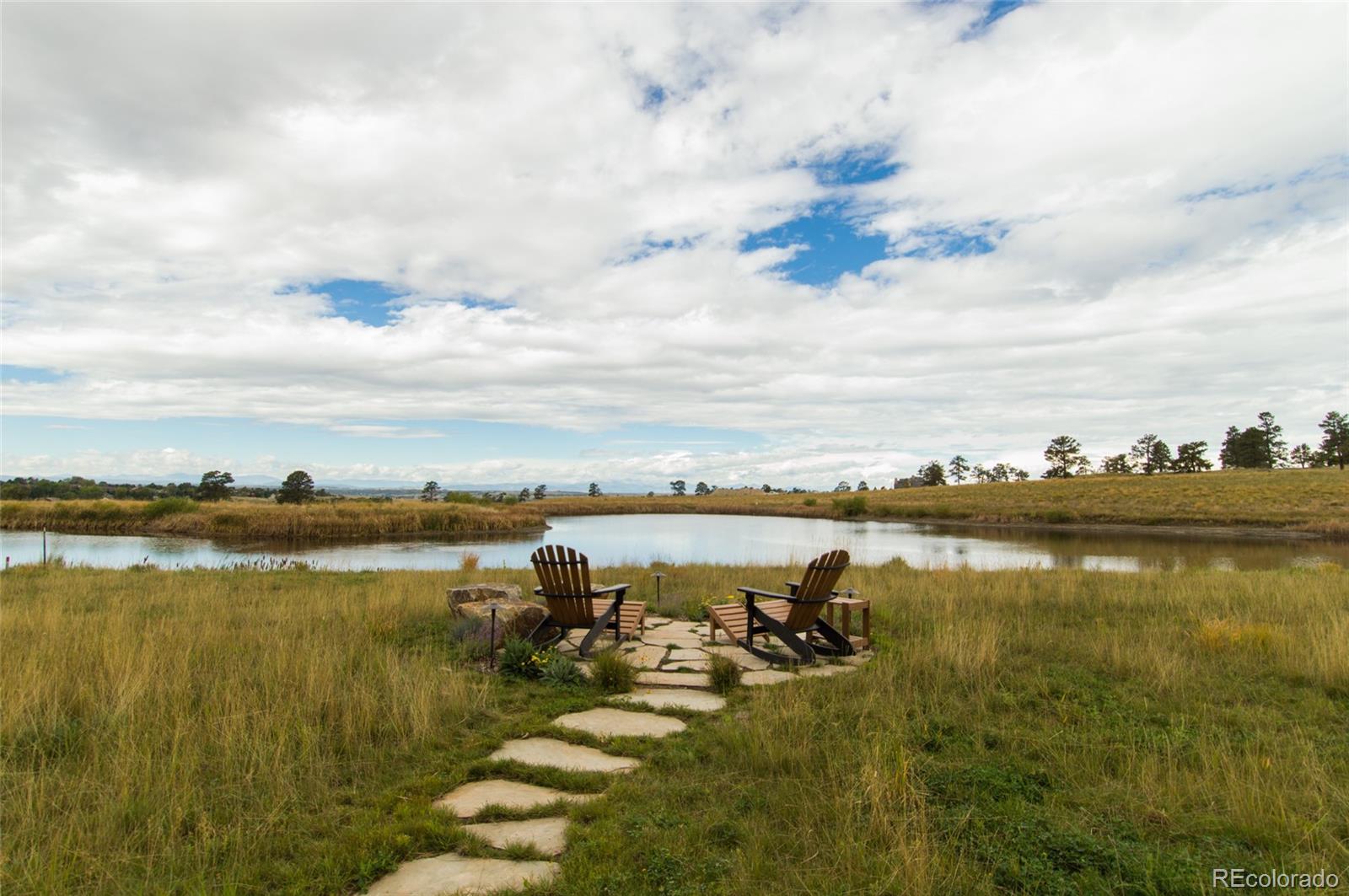 7921 Forest Keep Circle Parker, CO 80134 - Photo 34 of 36 a view of a lake with houses in the back