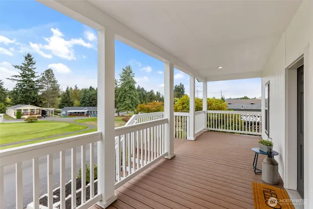 a view of a porch with wooden floor and fence