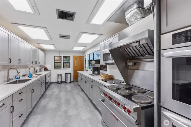 a kitchen with sink stove and cabinets