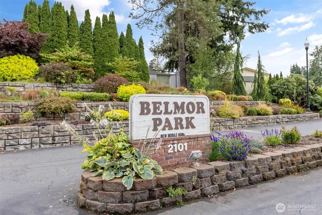 a sign that is sitting in front of flowers