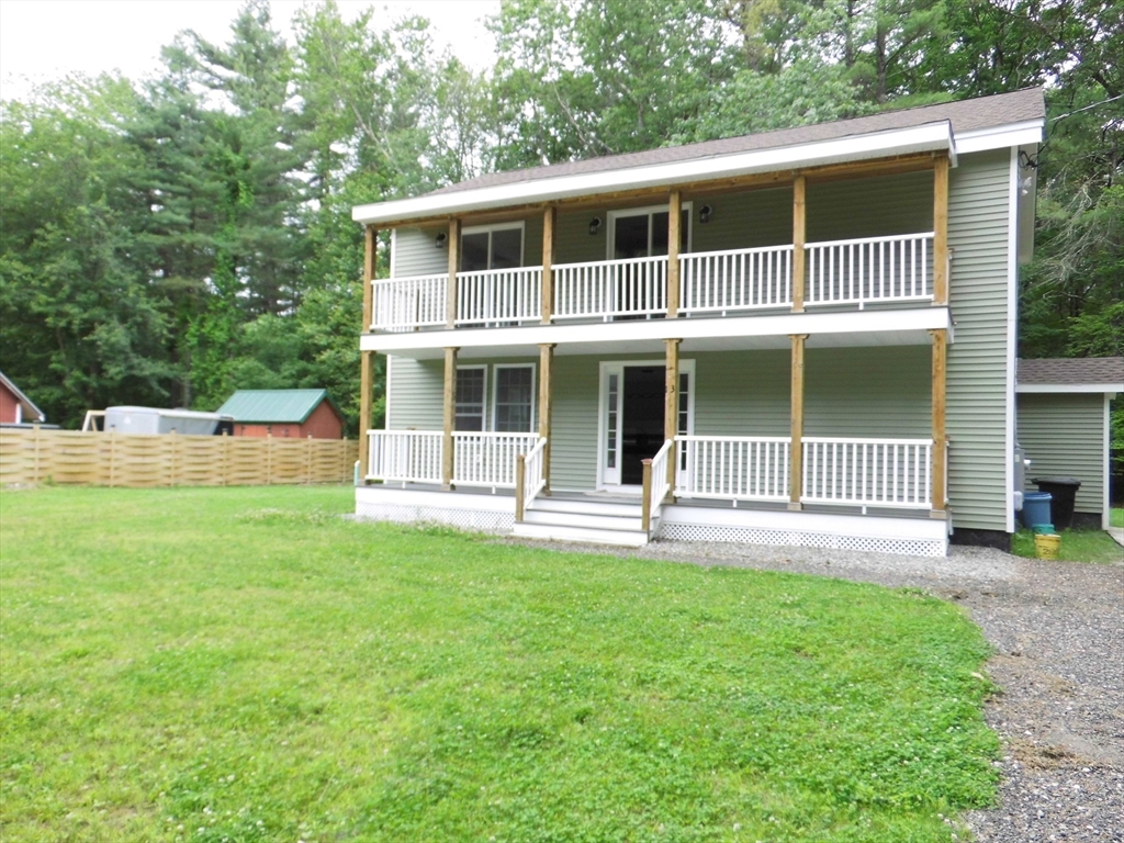 13 Showell Pond Road Sandown, NH 03873 - Photo 1 of 42 a front view of a house with a yard and porch