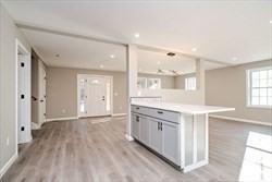 13 Showell Pond Road Sandown, NH 03873 - Photo 15 of 42 a view of kitchen with wooden floor and windows