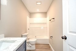 13 Showell Pond Road Sandown, NH 03873 - Photo 17 of 42 a bathroom with a granite countertop sink a toilet and shower