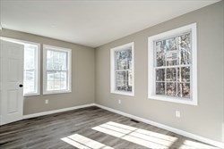 13 Showell Pond Road Sandown, NH 03873 - Photo 19 of 42 a view of an empty room with wooden floor and a window