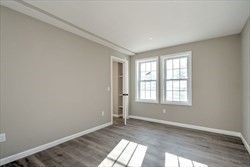 13 Showell Pond Road Sandown, NH 03873 - Photo 20 of 42 an empty room with wooden floor and windows
