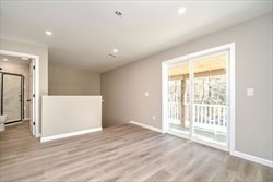 13 Showell Pond Road Sandown, NH 03873 - Photo 21 of 42 an empty room with wooden floor and windows
