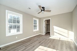 13 Showell Pond Road Sandown, NH 03873 - Photo 27 of 42 a view of an empty room with a window and wooden floor