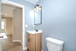 13 Showell Pond Road Sandown, NH 03873 - Photo 30 of 42 a bathroom with a sink vanity mirror and toilet