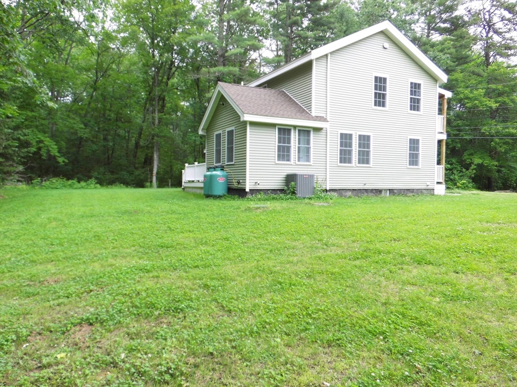 13 Showell Pond Road Sandown, NH 03873 - Photo 3 of 42 a view of a house with a backyard