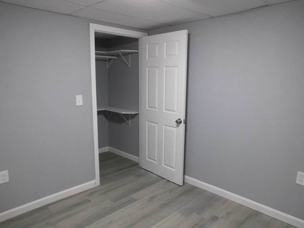 13 Showell Pond Road Sandown, NH 03873 - Photo 36 of 42 an empty room with wooden floor & closet