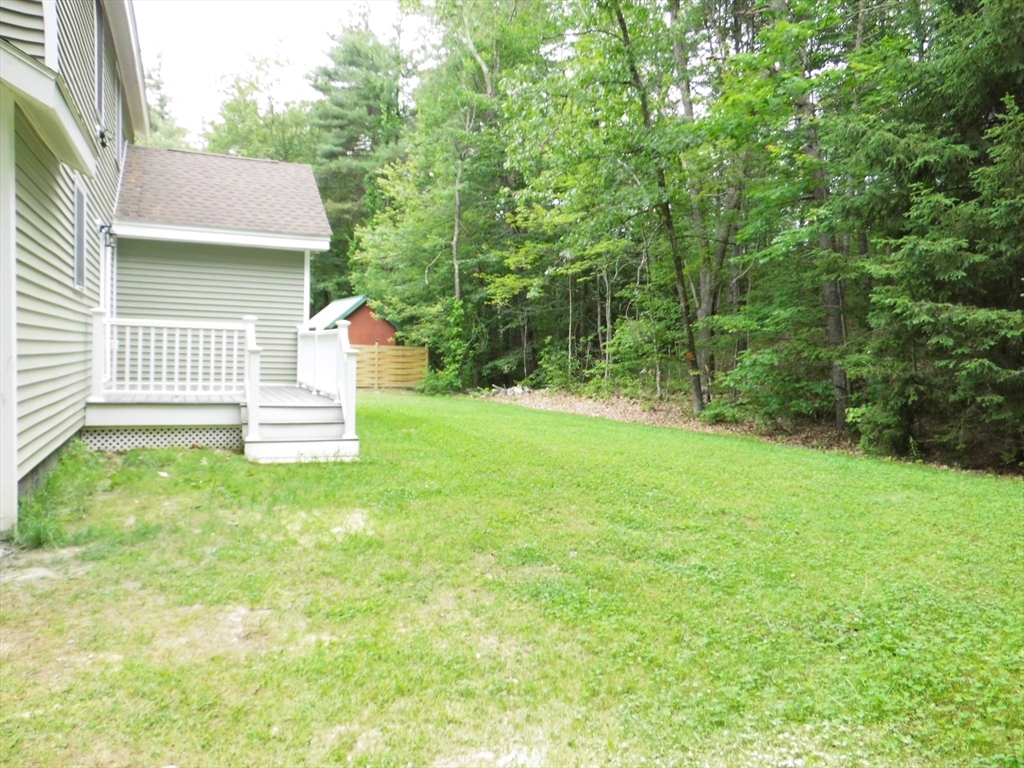 13 Showell Pond Road Sandown, NH 03873 - Photo 5 of 42 a view of a house with a yard and a fence
