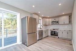 13 Showell Pond Road Sandown, NH 03873 - Photo 10 of 42 a kitchen with granite countertop stainless steel appliances a refrigerator sink and microwave