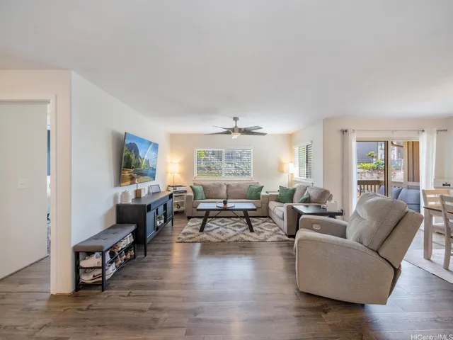 a living room with fireplace furniture and wooden floor