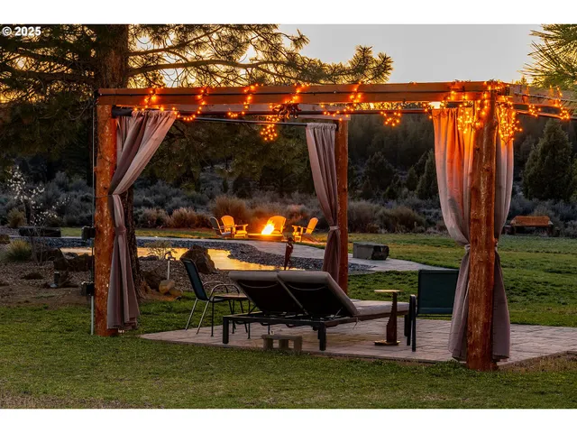a backyard of a house with table and chairs