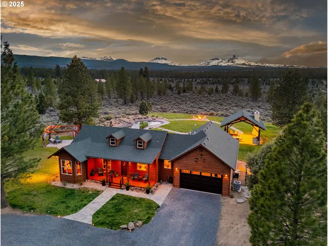 a view of a house with a swimming pool and a yard