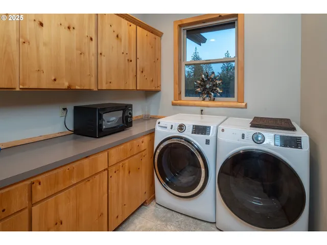 a view of a garage with a bike and white car
