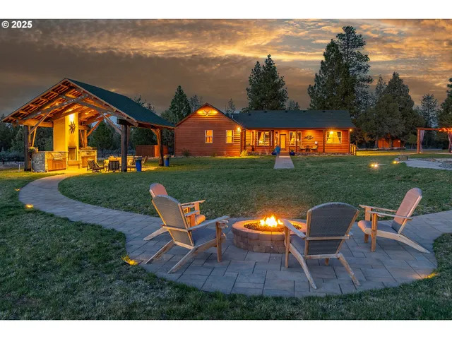 a backyard of a house with table and chairs