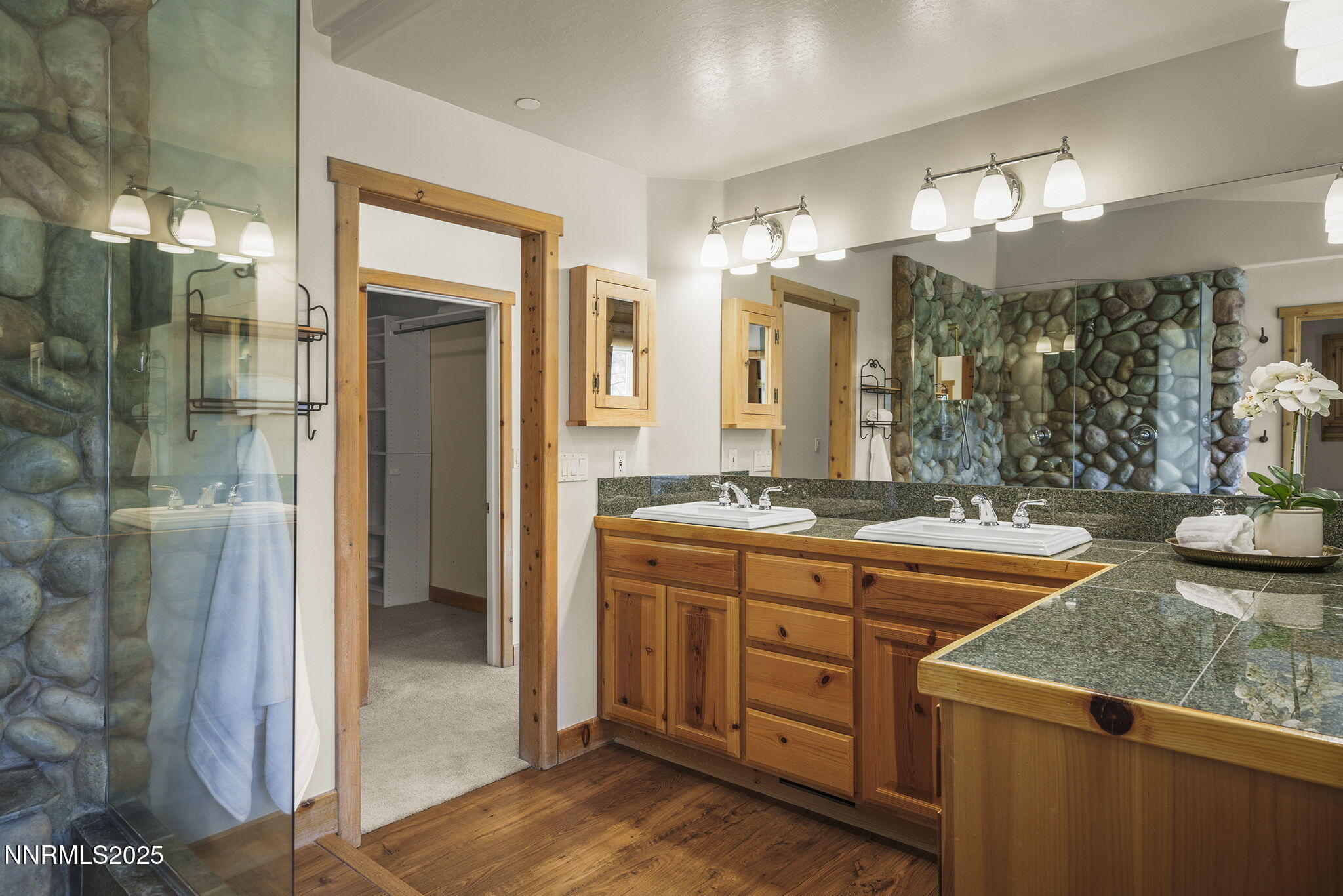 4684 Old Clear Creek Road Carson City, NV 89705 - Photo 29 of 46 a bathroom with a granite countertop sink a large mirror and a shower